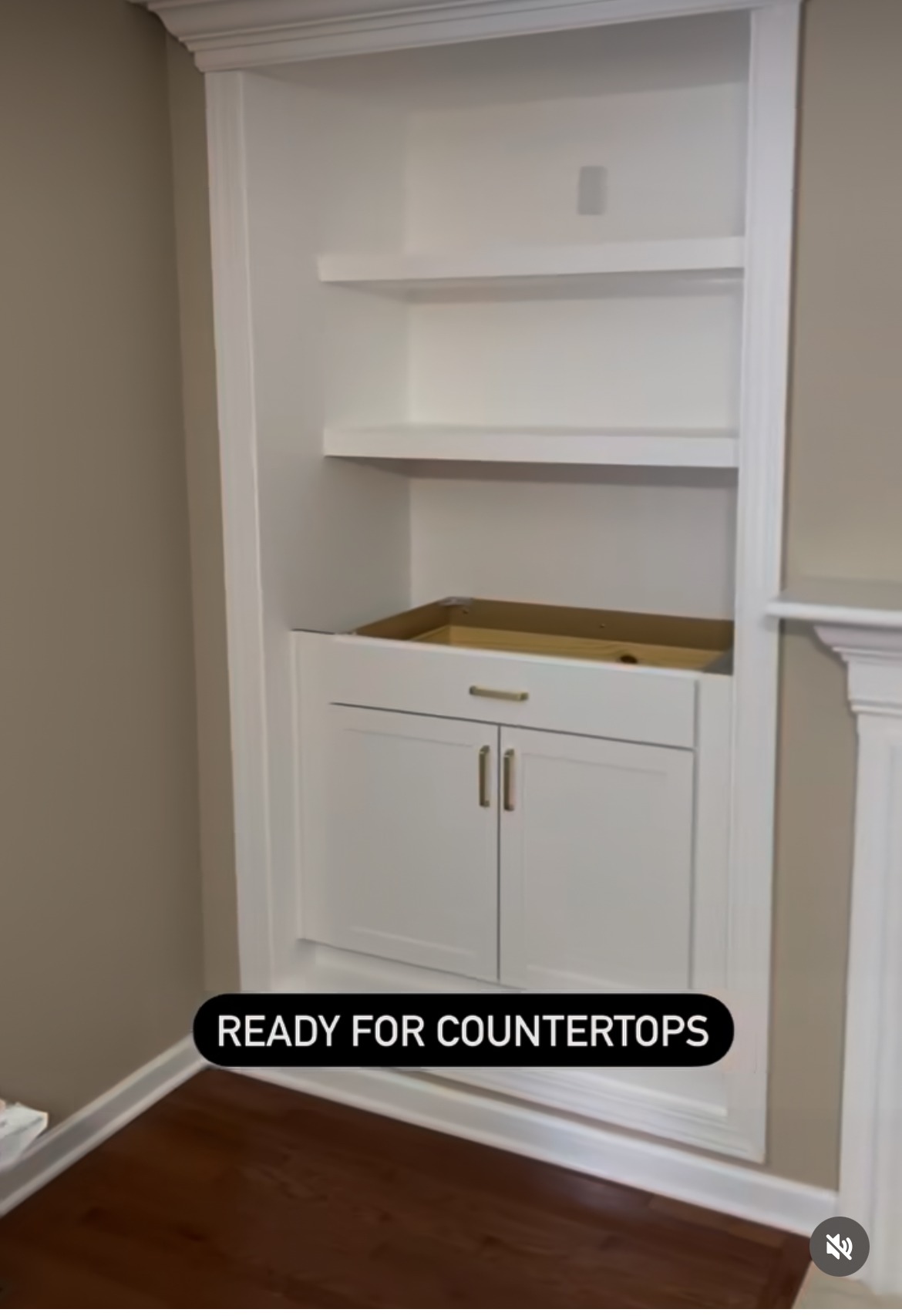 Built-in white shelving and cabinet