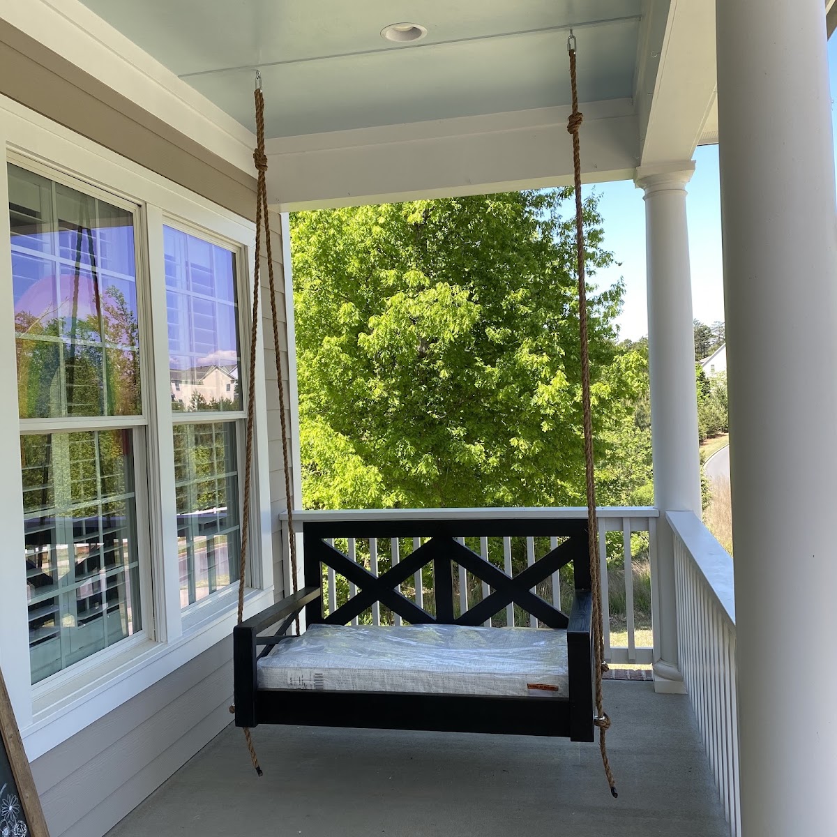 Hanging porch swing installed on a front porch